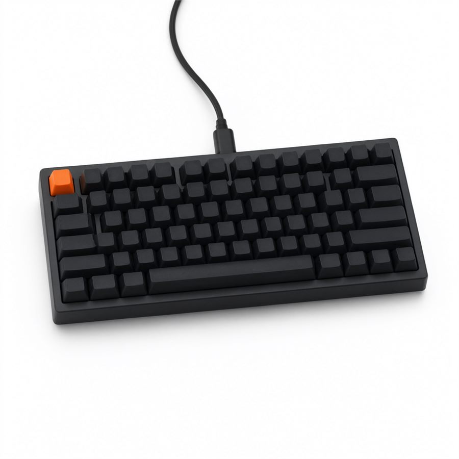 The ANVIL 75 in matte black — a compact 75 % board with blank charcoal keycaps, an orange escape cap, a thick bezel and an attached black cable. No lighting.